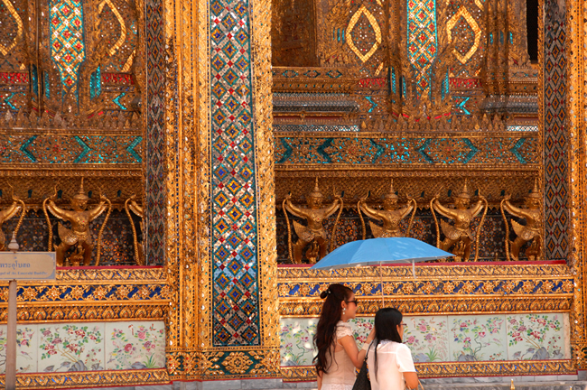 Visitors at the Grand Palace, one of the vibrant city's must-go-to spots, stroll past the Golden Gallery.