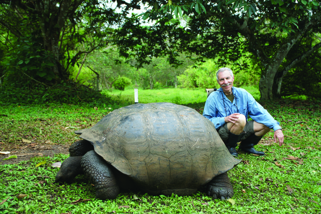 Writer Ed Wetschler poses with Galapagos’ famous tortoises.