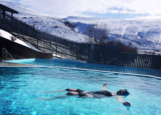 Outdoor thermal pools and hot tubs at the eco-friendly Hotel Husafell in Iceland.