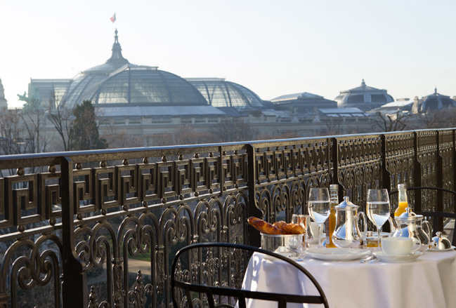 At La Reserve Paris, couples can meals on the property's rooftop overlooking the Grand Palais museum.