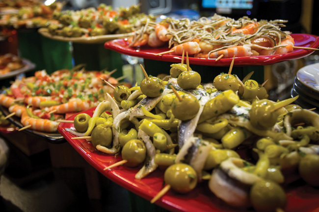 Silversea Cruises' menu of new culinary cruises allows passengers to immerse themselves in the foodie scenes in Europe and South. (Pictured: Pintxos (small snacks) at the Ribera Indoor Market in Bilbao, Spain.)