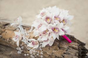 The elegant Seaside Shimmer ceremony features glamorous elements such as crystals and delicate rose accents.