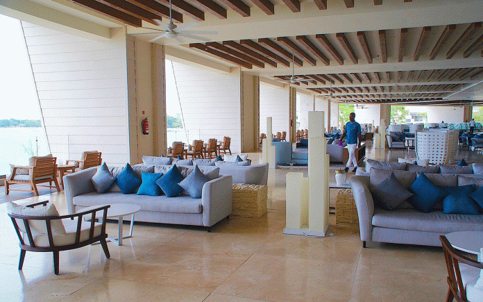 JAPEX Royalton Negril The lobby at Royalton Negril Resort & Spa brings beach vibes indoors with blue decor and water views.