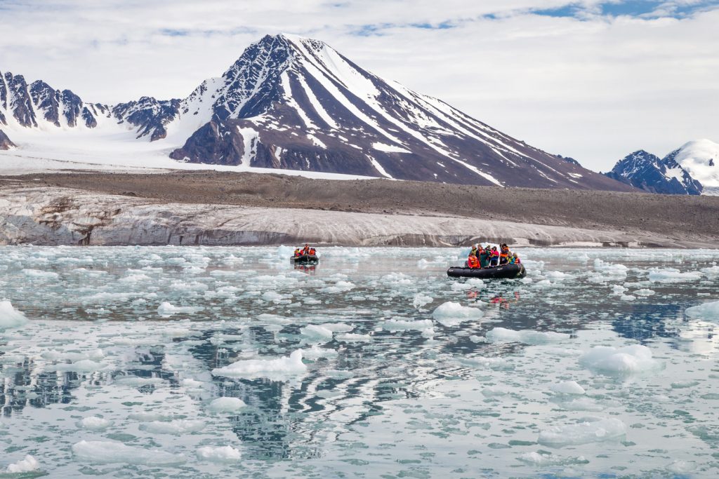 Guests take a zodiac expedition to explore on this Arctic Safari itinerary. (Photo credit: Joe Van Os, courtesy of TravelWild Expeditions.)