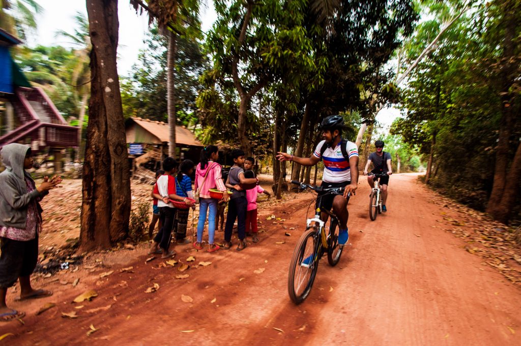 Bikers riding through local villages. (Photo courtesy of Grasshopper Adventures.)